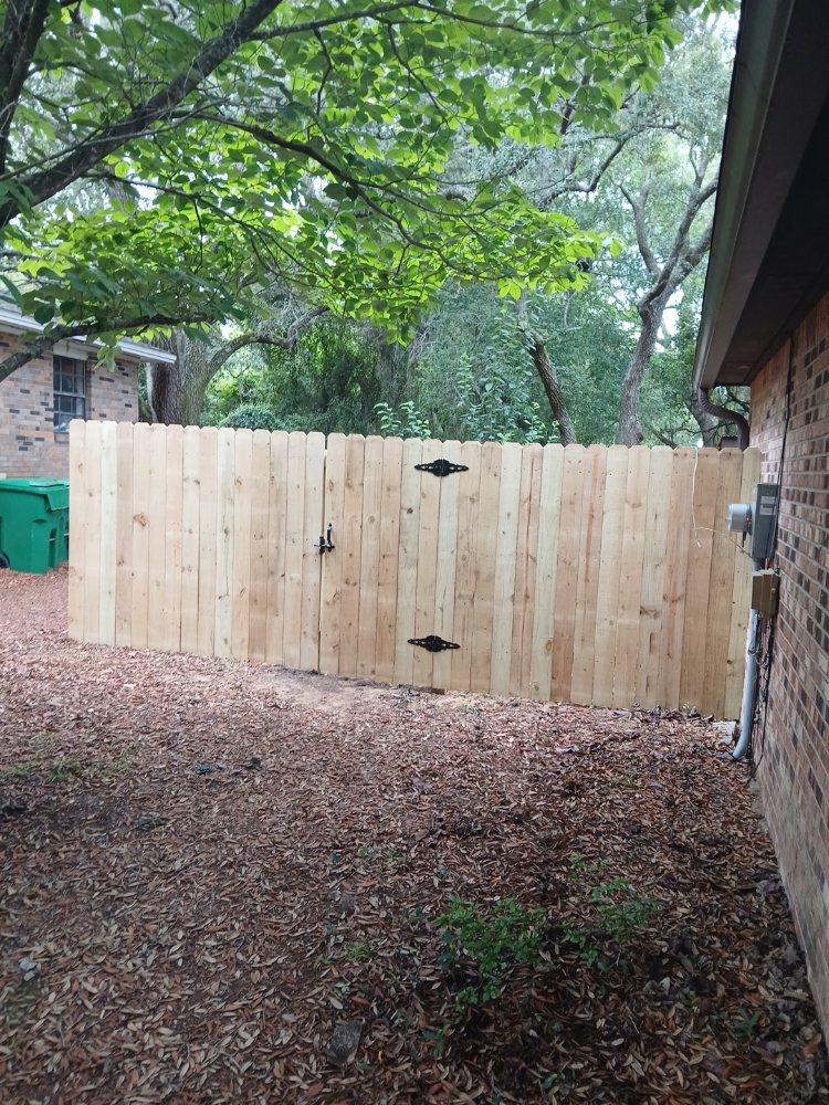 New cedar privacy fence with gate and black decorative hinges